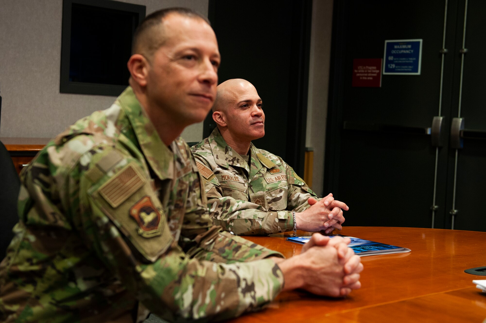 Chief Master Sgt. Lloyd Morales (right), 88th Air Base Wing command chief, and Chief Master Sgt. Carlos Labrador, National Air and Space Intelligence Center command chief, listen to NASIC personnel brief their capabilities at Wright-Patterson Air Force Base, Ohio, April 10, 2023. During Morales’ visit to NASIC, he toured the facility and spoke with many Airmen and Guardians to better understand the unique mission sets that exist at NASIC.