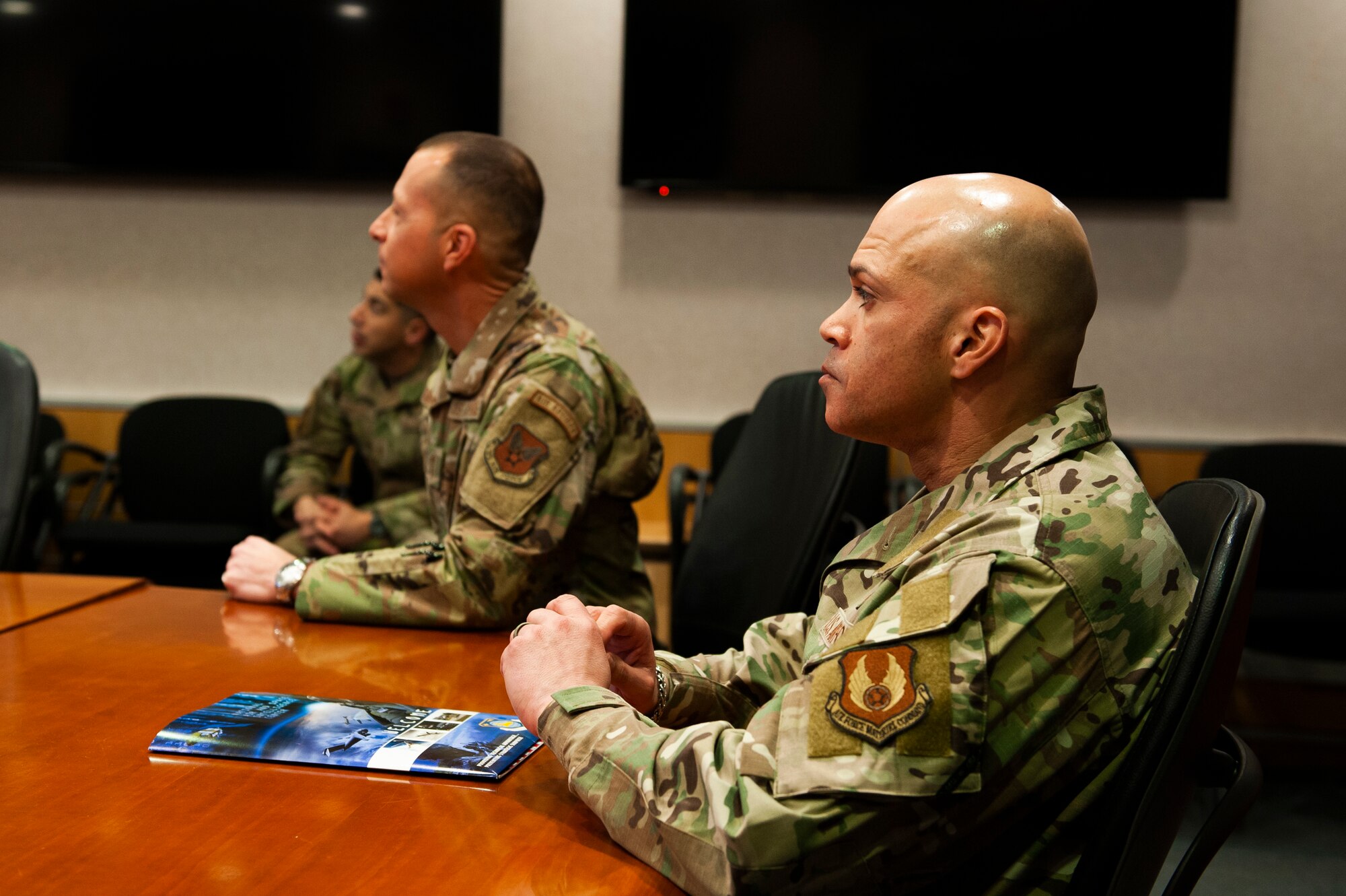 Chief Master Sgt. Lloyd Morales (right), 88th Air Base Wing command chief, and Chief Master Sgt. Carlos Labrador, National Air and Space Intelligence Center command chief, listen to a briefing from NASIC personnel brief their capabilities at Wright-Patterson Air Force Base, Ohio, April 10, 2023. During Morales’ visit to NASIC, he toured the facility and spoke with many Airmen and Guardians to better understand the unique mission sets that exist at NASIC.