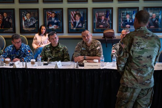  Senior ranking Foreign Air Attachés of a Secretary of the Air Force International Affairs (SAF/IA)-sponsored tour listen in during a Combined Force Space Component Command mission brief from U.S. Space Force Maj. Gen. Douglas A. Schiess, CFSCC commander, right, at Vandenberg Space Force Base, Calif., May 3, 2023. Hosted by CFSCC, the group consisted of 15 Foreign Air Attachés, all from different countries, who participated in space-related discussions. (U.S. Space Force photo by Tech. Sgt. Luke Kitterman)