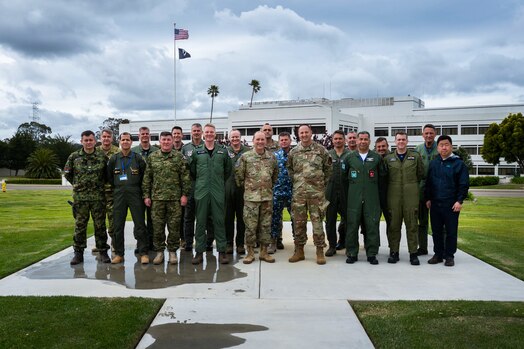  U.S. Space Force Maj. Gen. Douglas A. Schiess, Combined Force Space Component Command (CFSCC) commander, center, and U.S. Air Force Maj. Gen. Julian C. Cheater, Assistant Deputy Under Secretary of the Air Force International Affairs (SAF/IA), center right, stand for a group photo with participants of a SAF/IA-sponsored tour at Vandenberg Space Force Base, Calif., May 3, 2023. This DoD-level program aims to orient Attachés to DoD organizations and provide strategic messaging to senior foreign leaders, and is executed on behalf of the USAF Chief of Staff Gen. Charles Q. Brown. (U.S. Space Force photo by Tech. Sgt. Luke Kitterman)