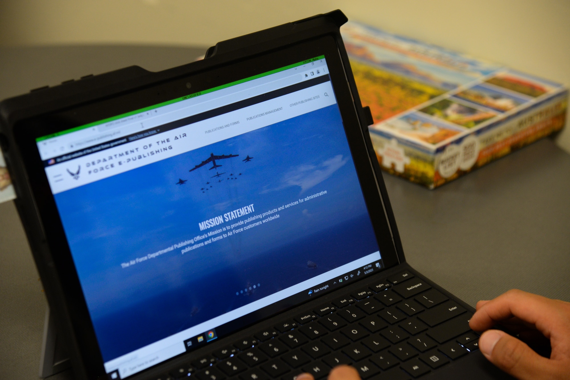 Airman using a computer to access a website