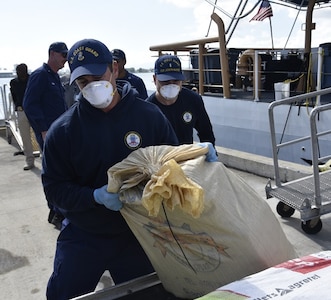 Coast Guard Cutter Joseph Napier crewmembers offload 901 pounds of cocaine in San Juan, Puerto Rico, May 3, 2023.  The cutter crew also transferred three suspected smugglers apprehended in this case were to federal agents, following the interdiction of a drug smuggling go-fast vessel north of Puerto Rico, April 29, 2023.  (U.S. Coast Guard photos)