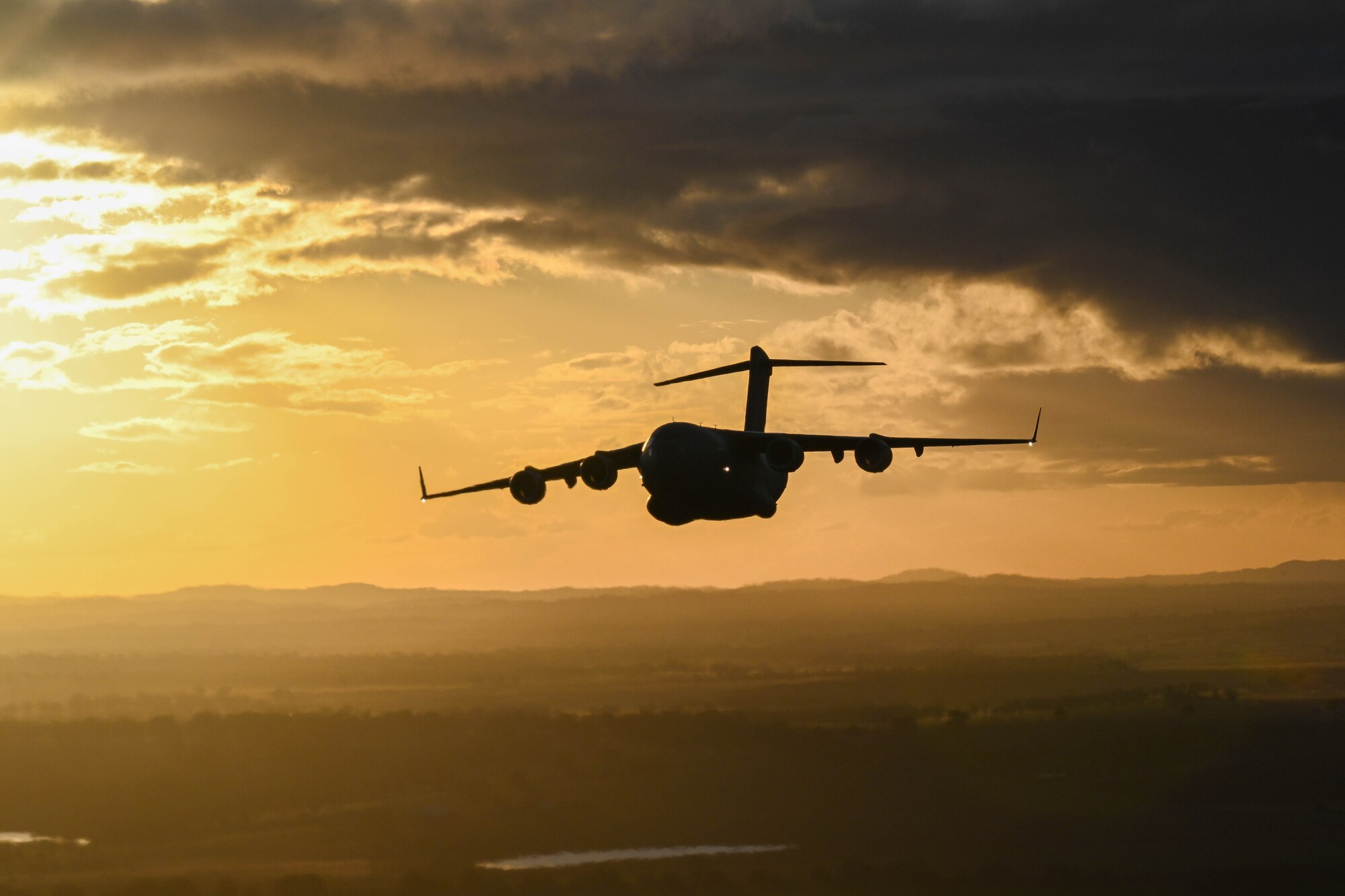 A Royal Australian Air Force C-17 Globemaster III flies in a two-ship formation during a training flight for Global Dexterity 23-1 at RAAF Base Amberley, Queensland, April 27, 2023. Exercise Global Dexterity 2023 is being conducted at Royal Australian Air Force Base Amberley, and is designed to help enhance air cooperation between the U.S. and Australia and increase our combined capabilities, improving security and stability in the Indo-Pacific region. (U.S. Air Force photo by Senior Airman Makensie Cooper)