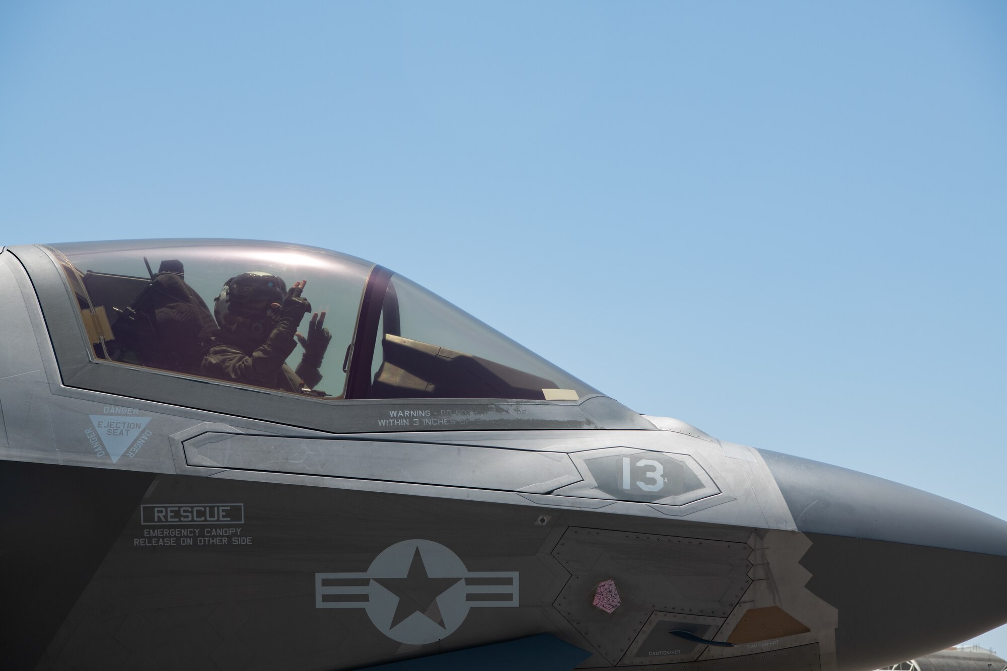A pilot poses in an aircraft.