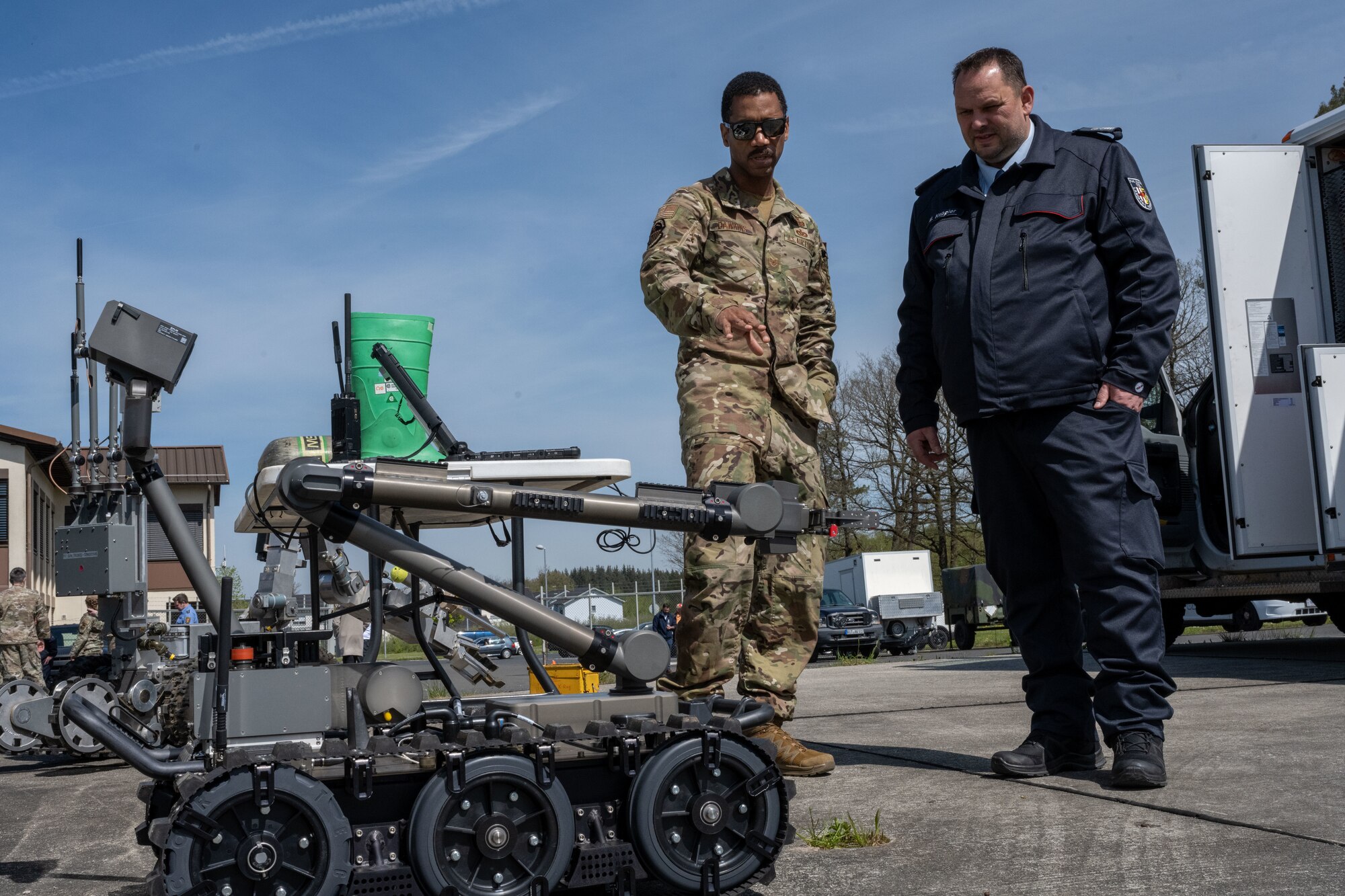 U.S. Air Force Tech. Sgt. Rhon Dawking, 52nd Civil Engineer Squadron Explosives Ordnance Disposal (EOD) training noncommissioned officer-in-charge, showcases an EOD robot to a German local national emergency responder