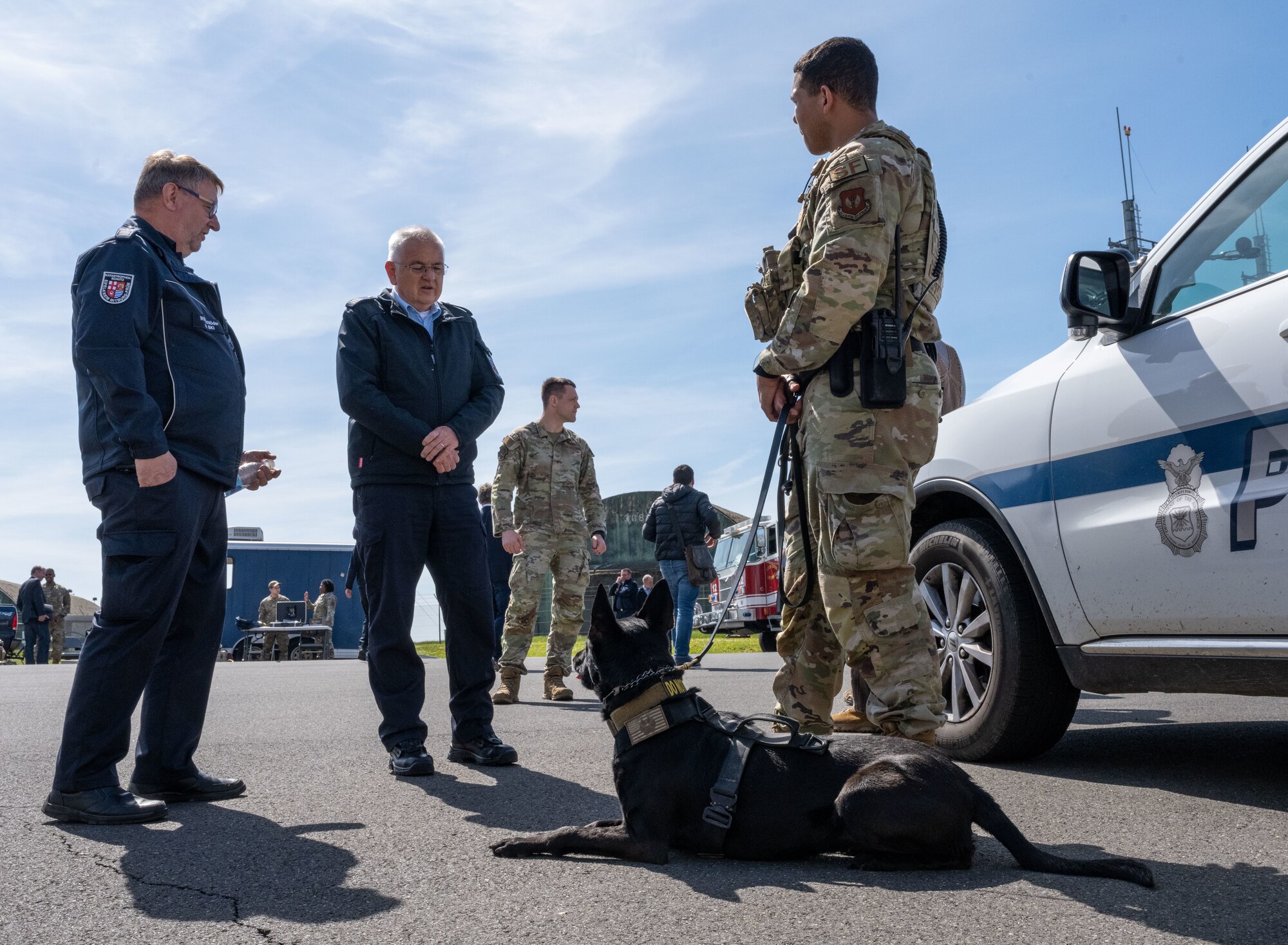 U.S. Air Force Staff Sgt. Ryan Wright, 52nd Security Forces Squadron military working dog (MWD) handler, showcases MWD Ccatalia to German local national emergency responders