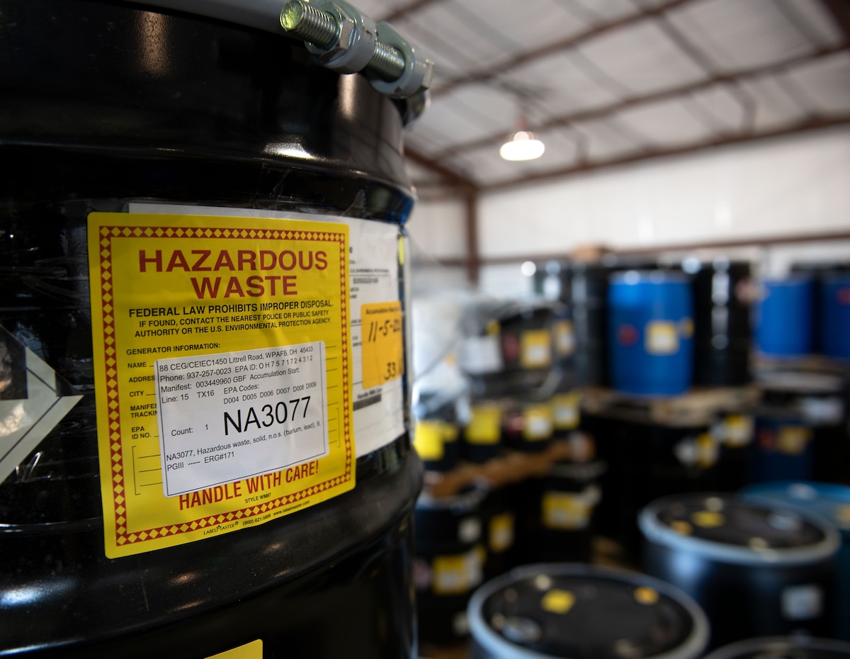 A hazardous waste barrel sits in a warehouse.