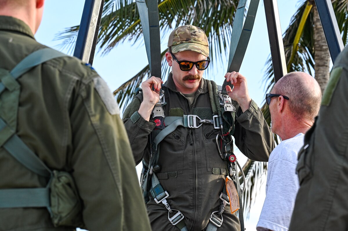 Senior Master Sgt. Rob Mitchell, a loadmaster assigned to the 757th Airlift Squadron, hangs in a parachute harness during water survival training on April 19, 2023, at Naval Air Station Key West, Florida.