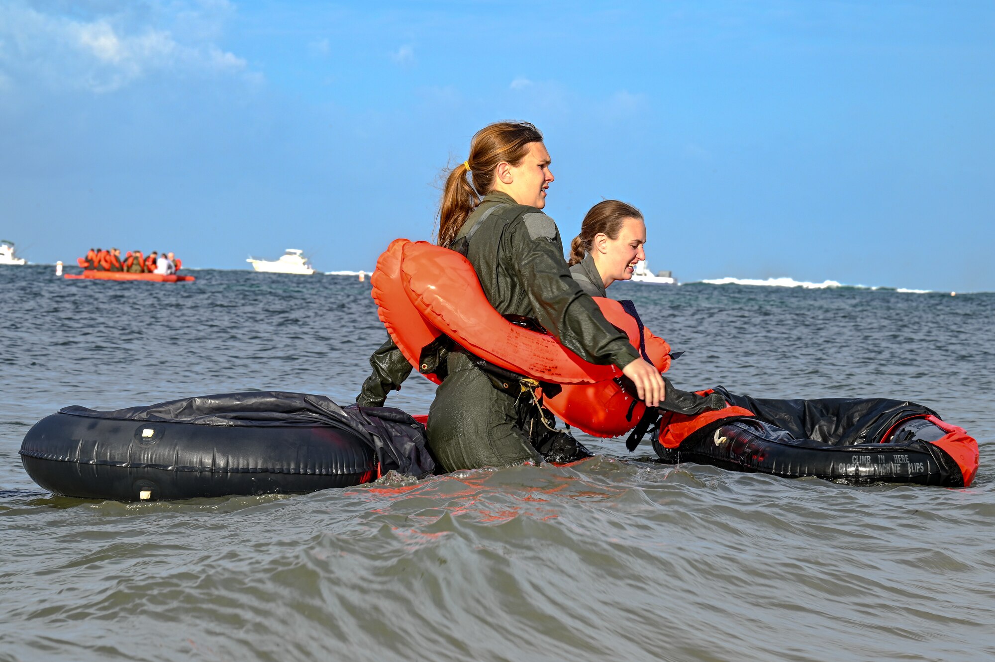 Staff Sgts. Micaiah McCartney and Kaleb Walker, loadmasters assigned to the 757th Airlift Squadron, walk to shore during water survival training on April 19, 2023, at Naval Air Station Key West, Florida.