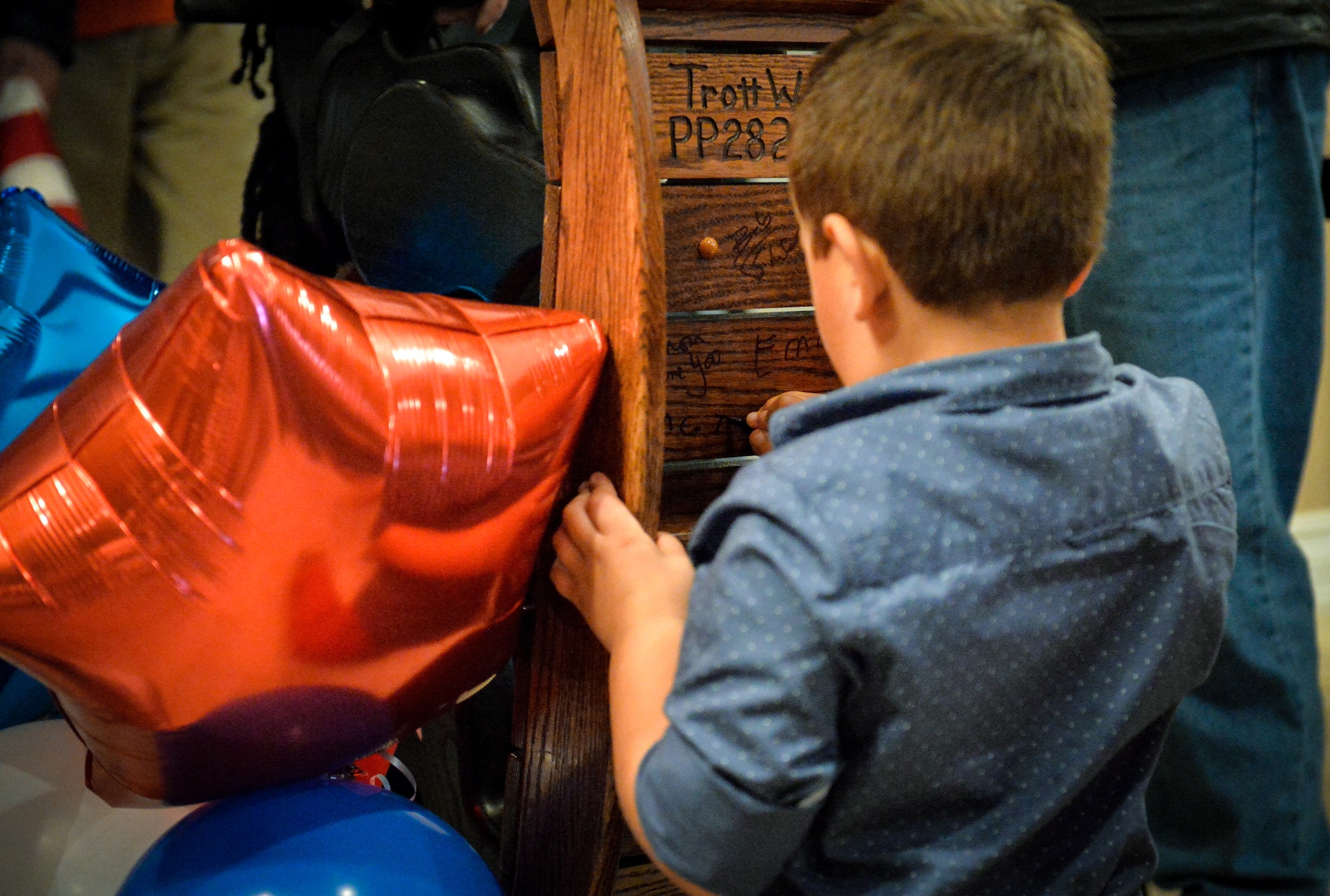 child signs rocking horse