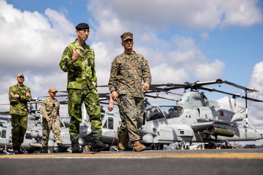 Swedish Armed Forces General Micael Byden, left, speaks with U.S. Marine Corps Col. Paul C. Merida, Commanding Officer of the 22nd Marine Expeditionary Unit, during a ship tour aboard the Wasp-class amphibious assault ship USS Kearsarge (LHD 3) in Stockholm, Sweden, June 4, 2022. The Kearsarge Amphibious Ready Group and the 22nd MEU, under the command and control of Task Force 61/2, is on a scheduled deployment in the U.S. Naval Forces Europe area of operations, employed by U.S. Sixth Fleet to defend U.S., allied and partner interests. (U.S. Marine Corps photo by Sgt. Armando Elizalde)
