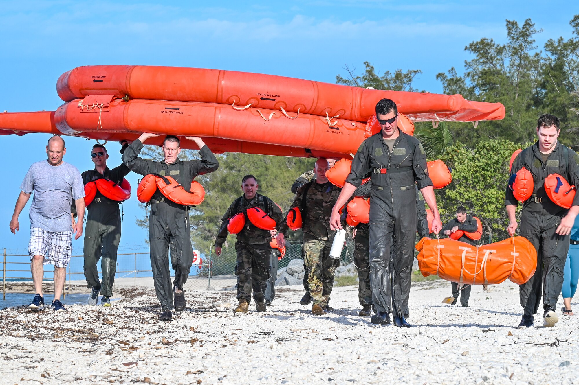 Reserve Citizen Airmen assigned to the 910th Airlift Wing carry a 20-person life raft during water survival training on April 19, 2023, at Naval Air Station Key West, Florida.