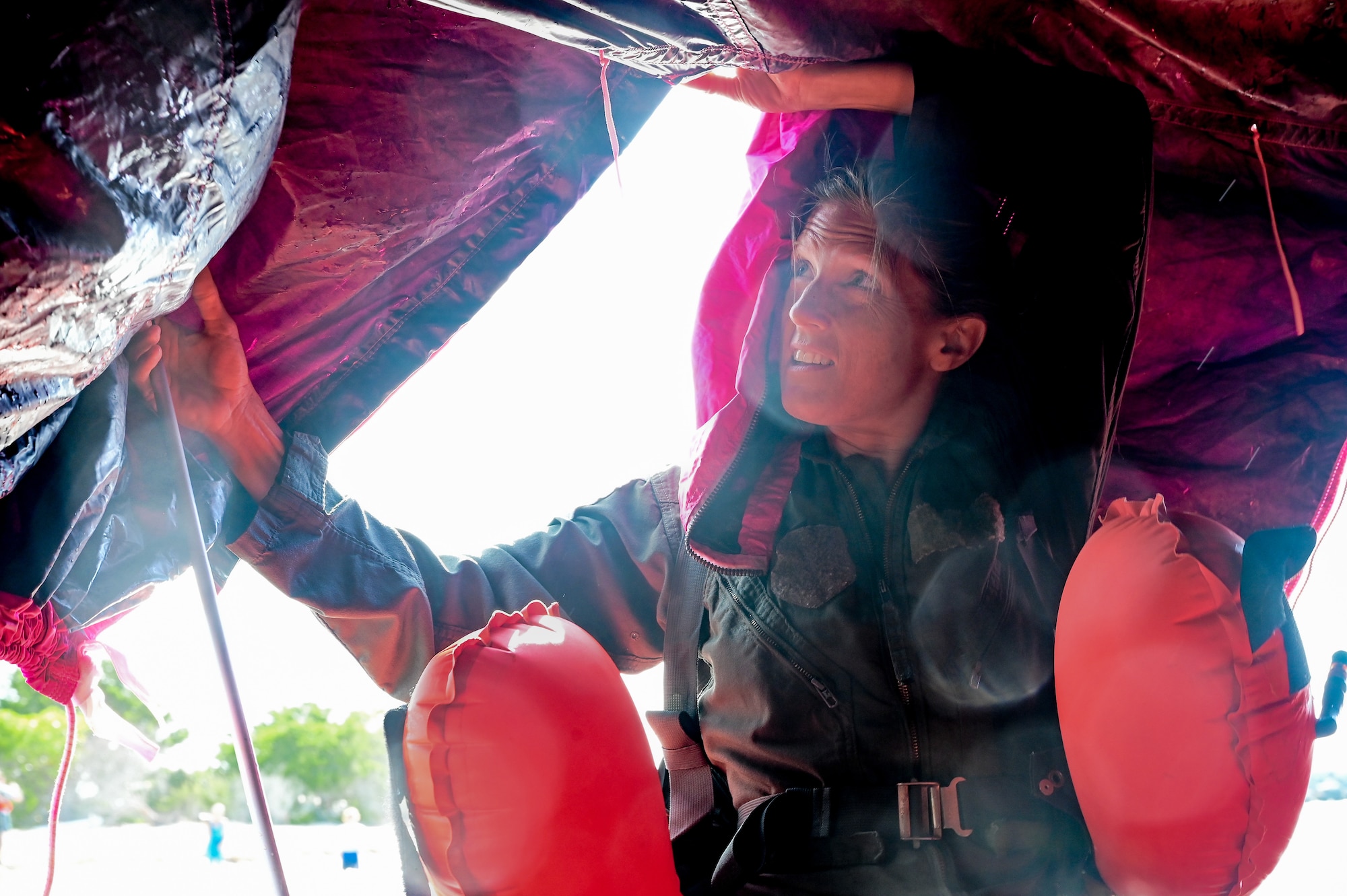 Maj. Shannon Baker, an instructor navigator assigned to the 757th Airlift Squadron, assemblies the 20-person life raft canopy during water survival training on April 19, 2023, at Naval Air Station Key West, Florida.