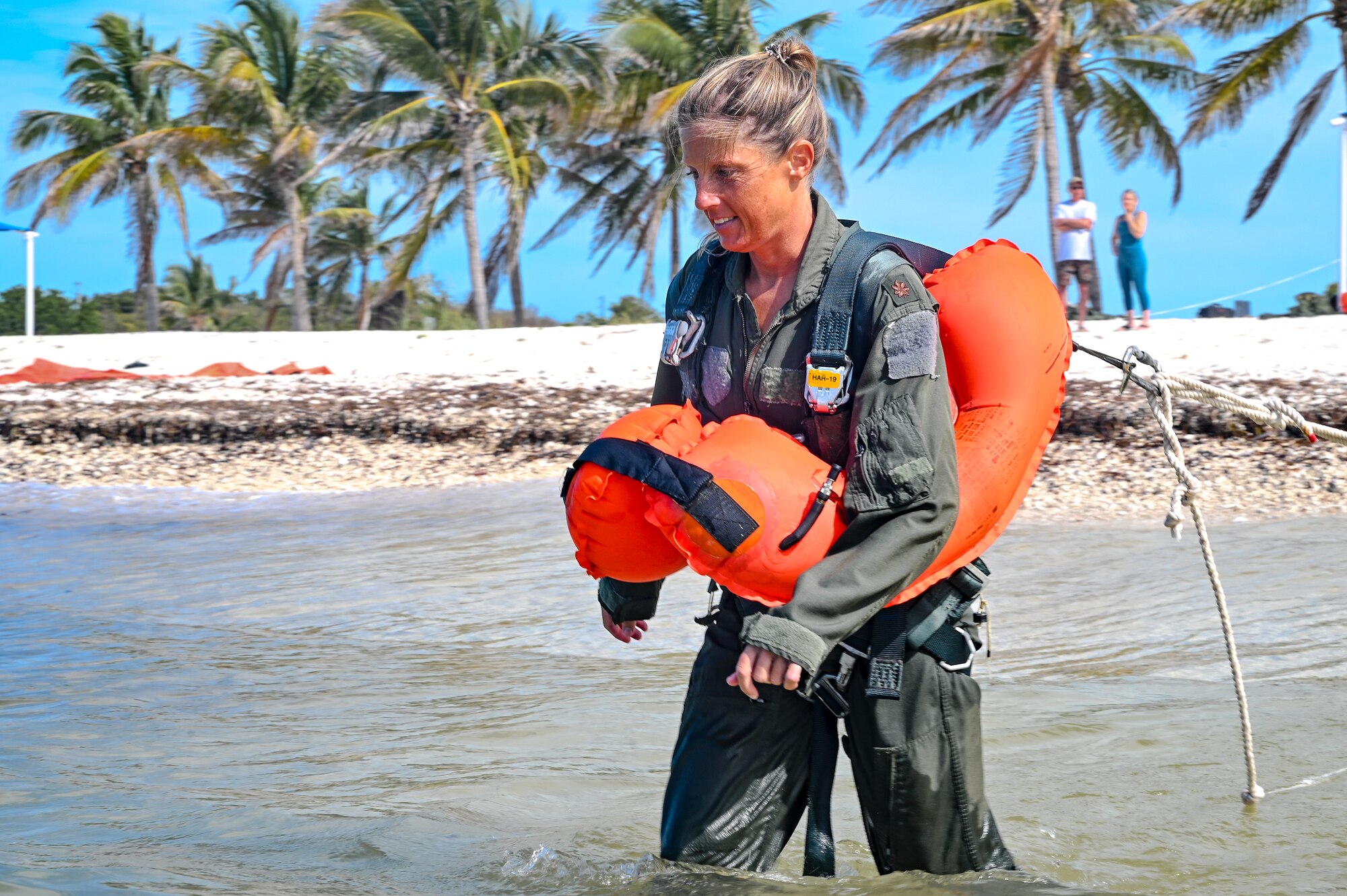 Maj. Shannon Baker, an instructor navigator assigned to the 757th Airlift Squadron, walks into the water during water survival training on April 19, 2023, at Naval Air Station Key West, Florida.