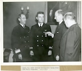 "Lieut. R. L. Burke receives Distinguished Flying Cross from Sec/y. Morgenthau," with USCG Commandant RADM Russell Waesche in attendance, 1938.