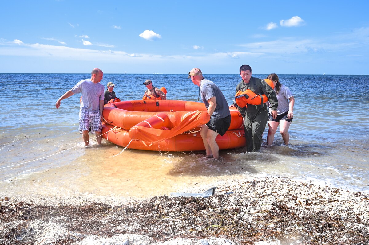 Reserve Citizen Airmen assigned to the 910th Airlift Wing carry a 20-person life raft out of the ocean during water survival training on April 19, 2023, at Naval Air Station Key West, Florida.