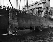 Landing craft pick up disembarking combat troops aboard USS Joseph T. Dickman somewhere in the Pacific Theater during World War II.