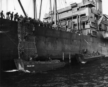 Landing craft pick up disembarking combat troops aboard USS Joseph T. Dickman somewhere in the Pacific Theater during World War II.