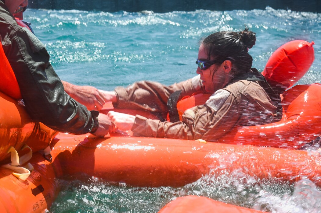 Lt. Col. Lisa Ballas, 910th Operations Support Squadron commander, climbs into a 20-person life raft during a mass casualty rescue exercise on April 19, 2023, at Naval Air Station Key West, Florida.