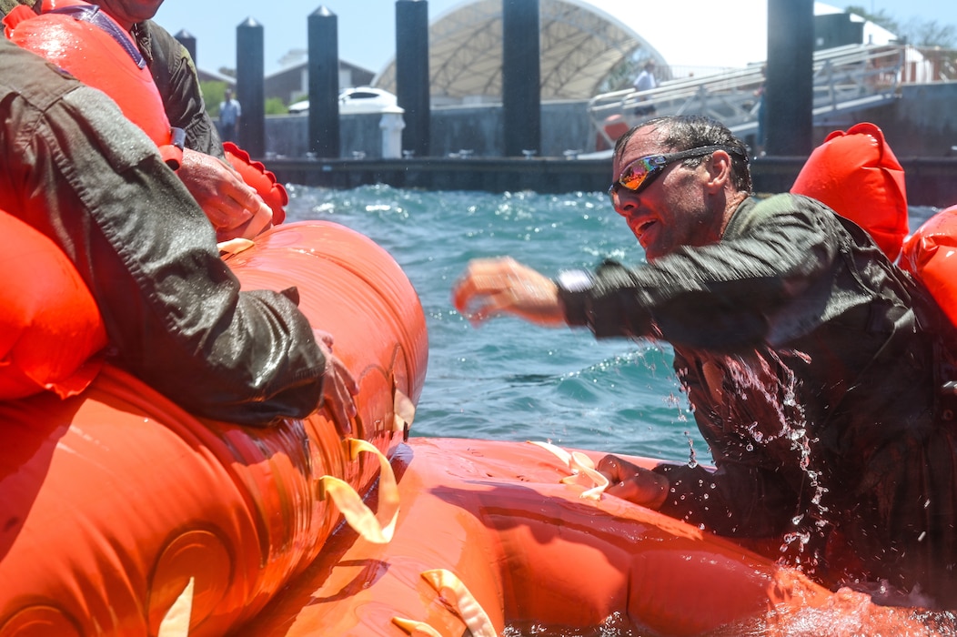 Lt. Col. Chris May, the chief pilot assigned to the 757th Airlift Squadron, climbs into a 20-person lift raft during a mass casualty rescue exercise on April 19, 2023, at Naval Air Station Key West, Florida.