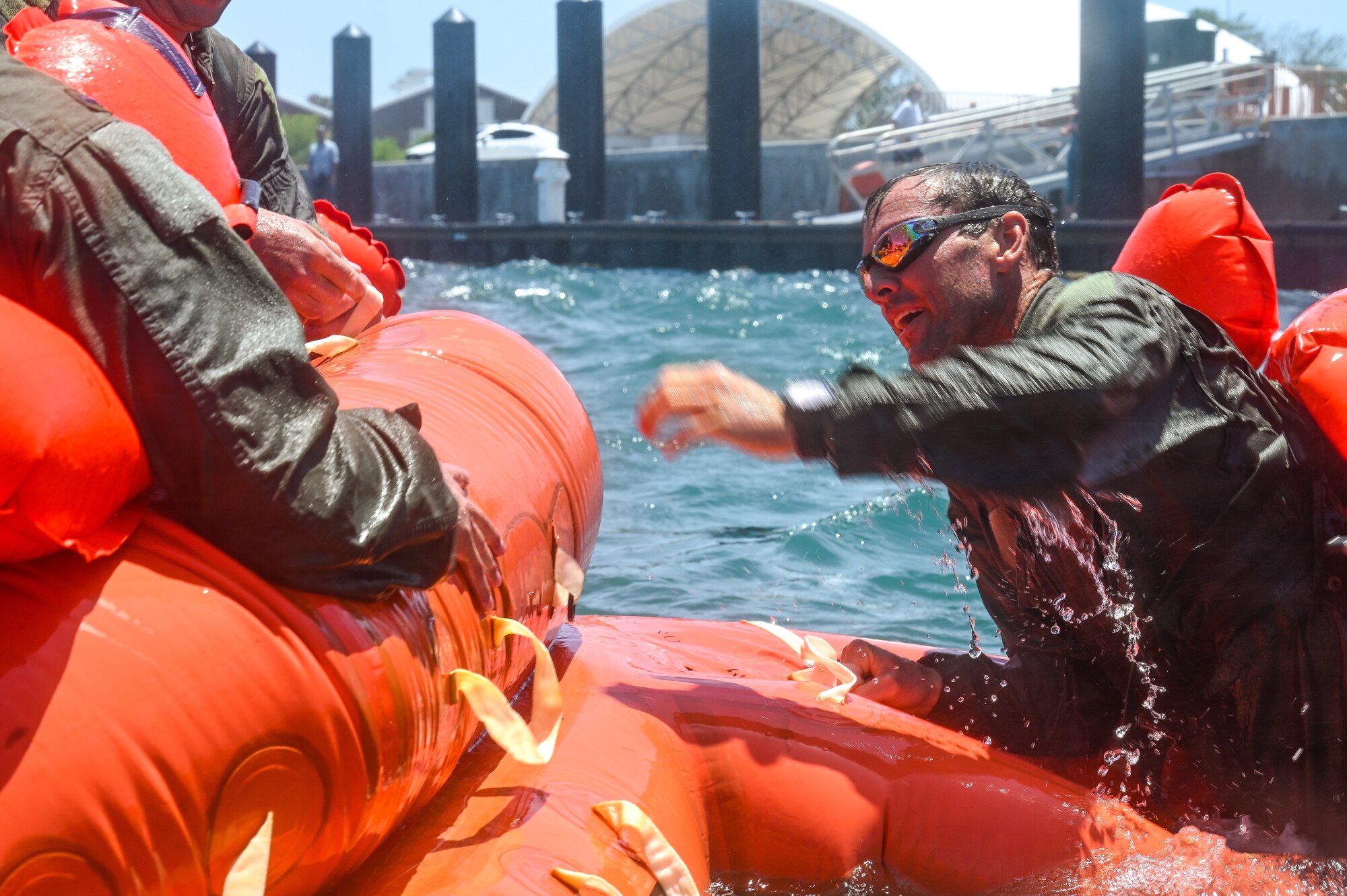 Lt. Col. Chris May, the chief pilot assigned to the 757th Airlift Squadron, climbs into a 20-person lift raft during a mass casualty rescue exercise on April 19, 2023, at Naval Air Station Key West, Florida.