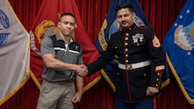 Christian Holmes shakes the hand of his recruiter, Staff Sgt. Salinas of Recruiting Station Chicago after his Oath of Enlistment  ceremony at Chicago's Military Enlistment Processing Station, Chicago, IL, April 22, 2023. Holmes is a graduate of Carmel Catholic High School and is enlisting into the United States Marine Corps in where he will ship to bootcamp sometime this summer in hopes of earning the title, Marine. (U.S. Marine Corps Photo by Sgt. Dalton J. Payne)