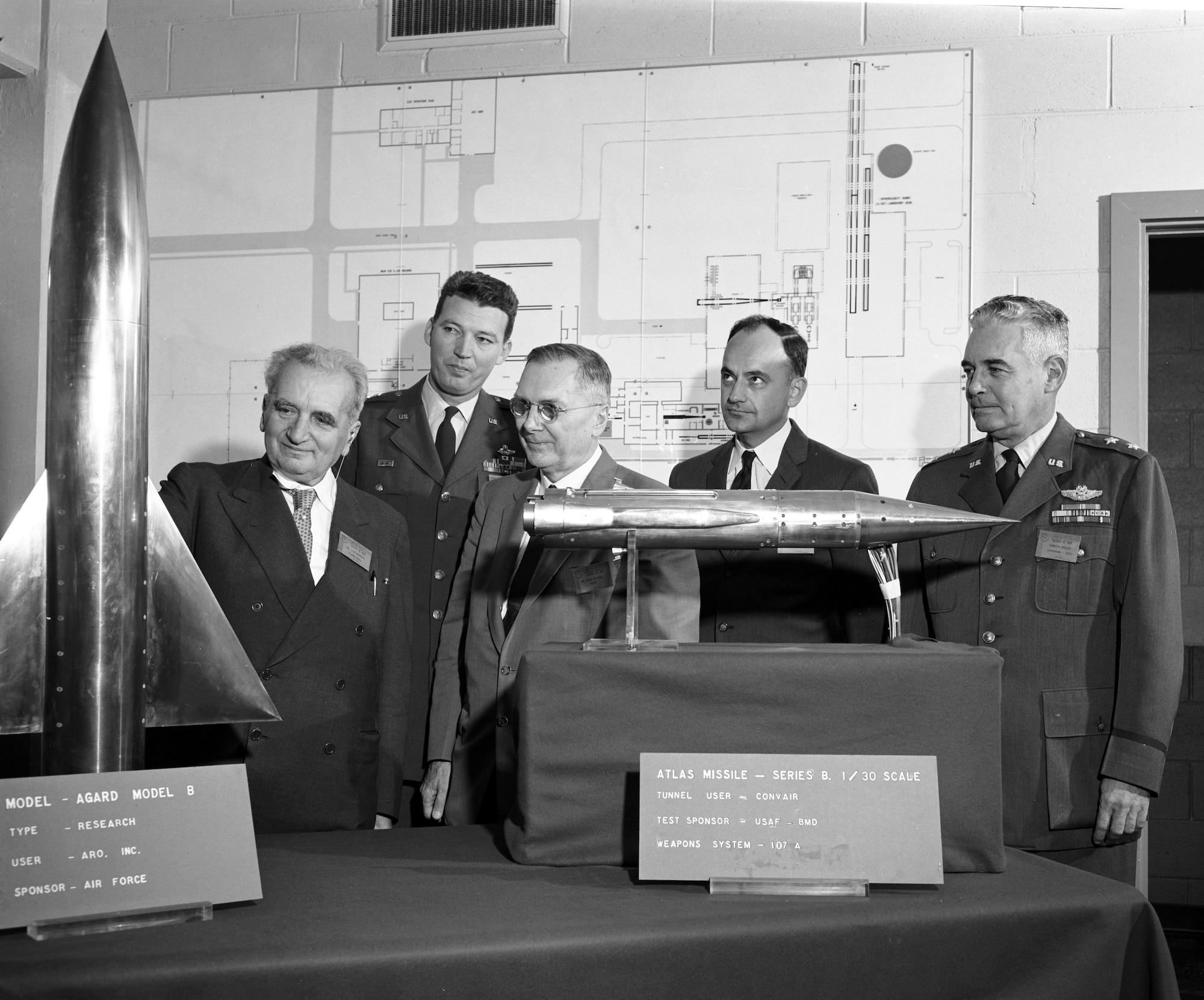 Dr. Theodore von Kármán, left, is joined by Air Force and NASA officials while inspecting two of the models used in the high velocity, high altitude wind tunnels at Arnold Air Force Base, Tenn. Von Kármán was able to get an up-close look at the models during the Oct. 30, 1959, dedication of the Gas Dynamics Facility at Arnold AFB in his honor. The site, now the headquarters of Arnold Engineering Development Complex, is the result of recommendations von Kármán made in 1945 to the late Gen. Hap Arnold, then-commander of the American Air Forces. Pictured with von Kármán are, from left, then-Lt. Gen. Bernard A. Schriever, then-commander of the Air Research and Development Command; Dr. Hugh Dryden, then-deputy administrator of the National Aeronautics and Space Administration; Dr. J.V. Charyk, then-assistant secretary of the Air Force for research and development; and then-Maj. Gen. Troup Miller Jr., then-commander of the AEDC. (U.S. Air Force photo)