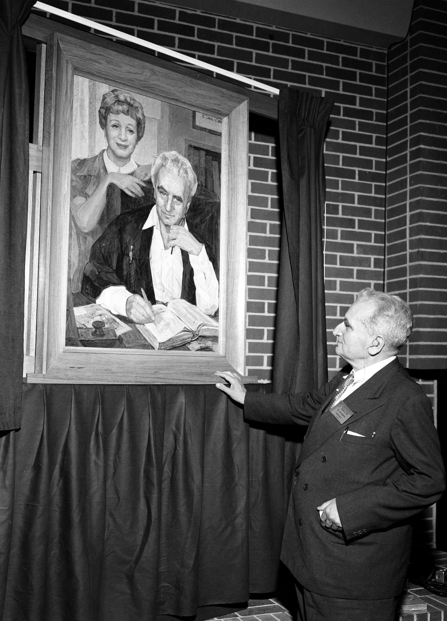 Dr. Theodore von Kármán looks at a painting of himself and his sister Dr. Josephine de Kármán unveiled as part of the events surrounding the Oct. 30, 1959, dedication of the Gas Dynamics Facility at Arnold Air Force Base, Tenn., in honor of von Kármán. (U.S. Air Force photo)