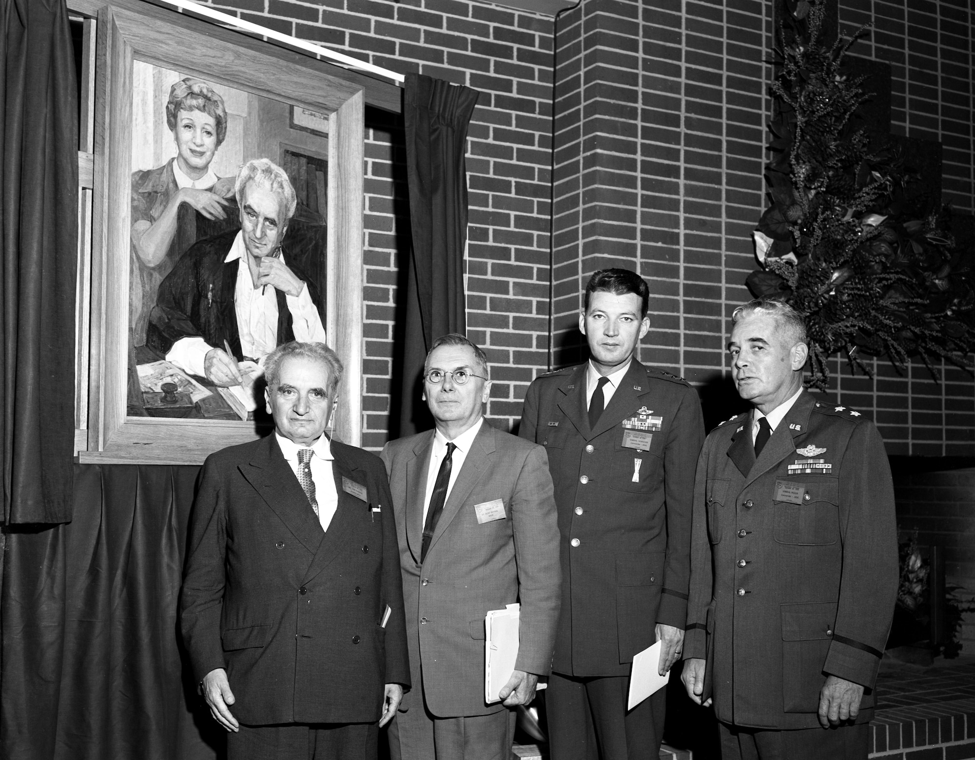 Dr. Theodore von Kármán; Dr. Hugh Dryden, then-deputy administrator of the National Aeronautics and Space Administration; then-Lt. Gen. Bernard Schriever, then-commander of the Air Research and Development Command; and then-Maj. Gen. Troup Miller Jr., then-commander of Arnold Engineering Development Center, from left, pose for a photo below a portrait of von Kármán and his sister Dr. Josephine de Kármán as part of the events surrounding the Oct. 30, 1959, dedication of the Gas Dynamics Facility at Arnold Air Force Base, Tenn., in honor of von Kármán. (U.S. Air Force photo)