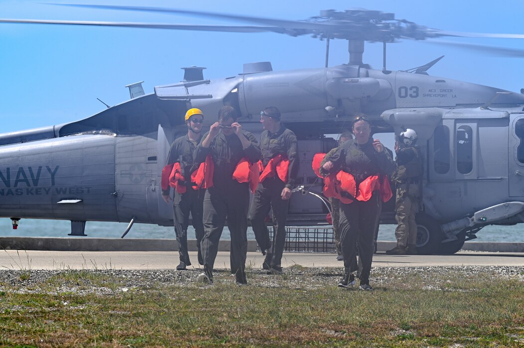 Reserve Citizen Airmen assigned to the 910th Operations Group disembark a MH-60S Multi-Mission Helicopter assigned to Naval Air Station Key West on April 19, 2023, at NAS Key West, Florida.