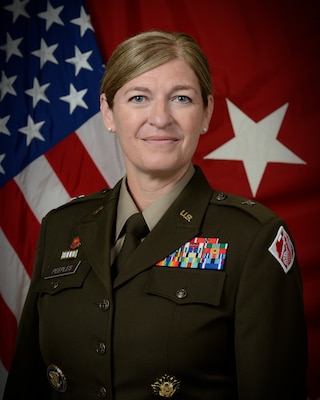 female Army officer in front of one-star flag