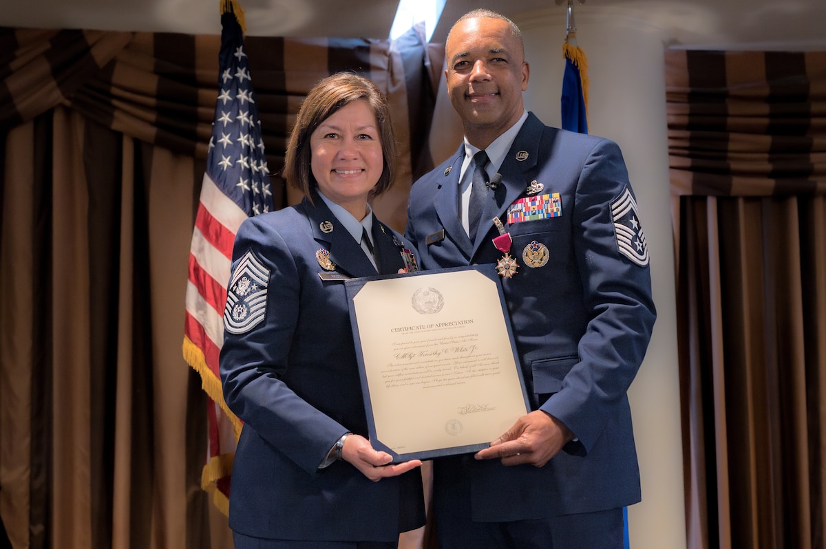 Photo of Chief Master Sergeant of the Air Force JoAnne Bass and Chief Master Sgt. Timothy White holding a certificate of appreciation.