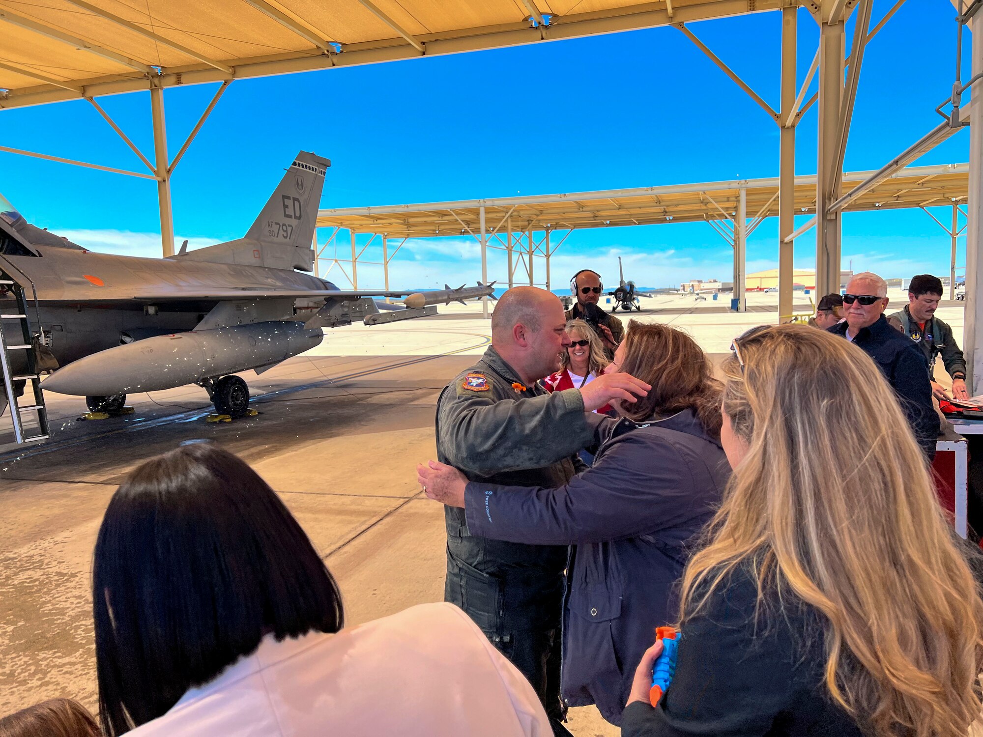 Lt. Col. Matthew Taranto, Chief Aerospace Physiologist, U.S. Air Force Test Pilot School greets his family after conducting his "fini-flight" before retirement March 31st. (Photo courtesy of Staff Sgt. Elizabeth Taranto)