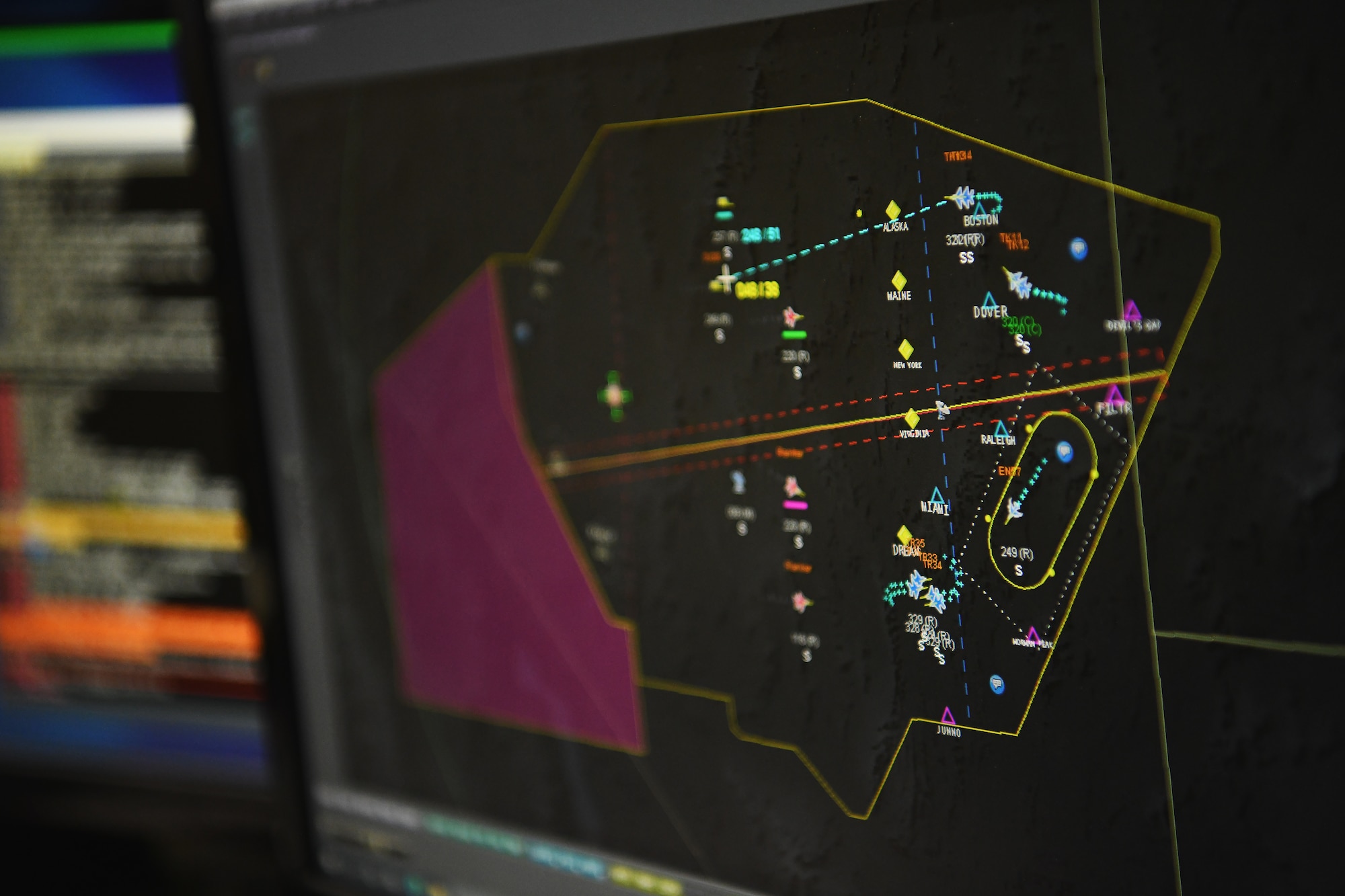 A screen displays a map of a simulated conflict during a joint training exercise with NATO partners April 28, 2023 in Blue Ash, Ohio. The Air Force is working to harness emerging information and communications technology and artificial intelligence technologies to provide targeting and decision support with the speed, adaptability, and resilience needed to fight in a highly contested environment. (U.S. Air National Guard photo by Shane Hughes)