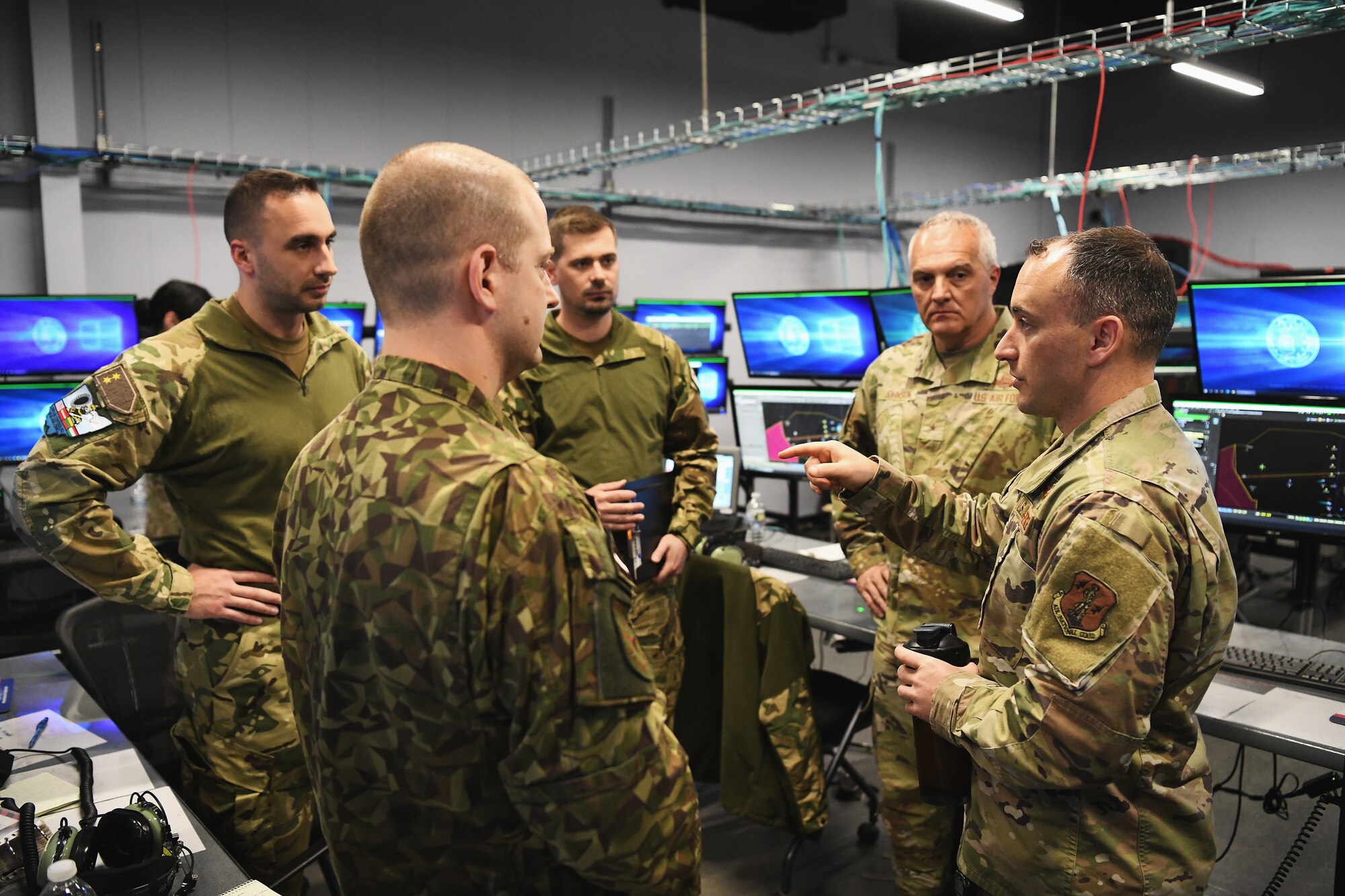 U.S. Air Force Maj. William Rief, senior operations officer assigned to the Ohio National Guard’s 123rd Air Control Squadron reviews lessons with service members from Lithuania, Latvia and Hungary during a joint training exercise April 28, 2023 in Blue Ash, Ohio. The Air Force is the global partner of preference for airpower and will be integrated with its allies and partners in future fights. (U.S. Air National Guard photo by Shane Hughes)