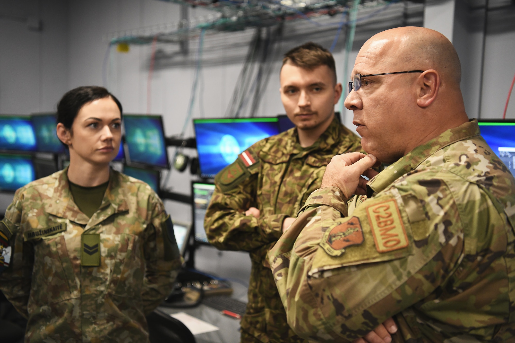 U.S. Air Force Chief Master Sgt. John Chestnut reviews training lessons with six service members from Lithuania, Latvia and Hungary during a joint training exercise April 28, 2023 in Blue Ash, Ohio. The training, which included air battle management, ground control intercept, large-force employment and air-to-air combat beyond visual range, began April 24th and concluded Friday. (U.S. Air National Guard photo by Shane Hughes)