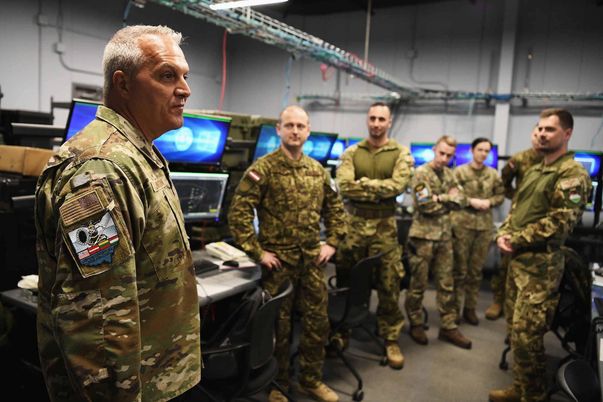 U.S Air Force Brig. Gen. David B. Johnson, assistant adjutant general for the Ohio Air National Guard, adresses airmen assigned to the 123rd Air Control Squadron and six service members from Lithuania, Latvia and Hungary during a joint training exercise Apr 28, 2023 in Blue Ash, Ohio. The training included air battle management, ground control intercept, large-force employment and air-to-air combat beyond visual range. (U.S. Air National Guard photo by Shane Hughes)