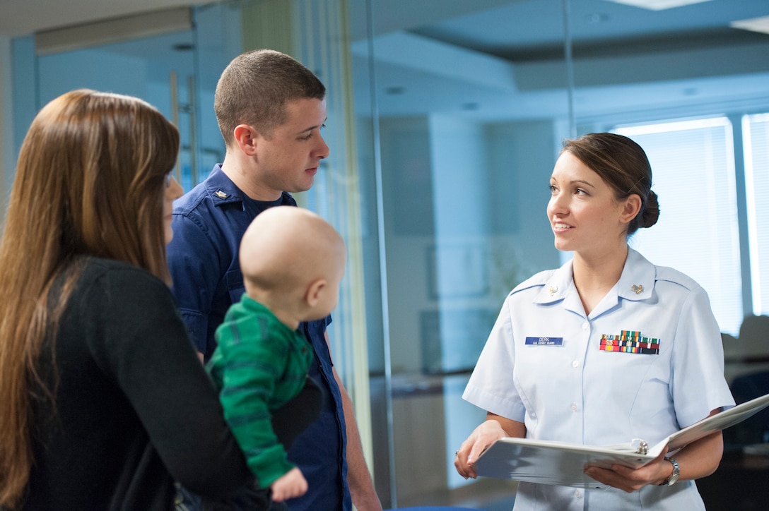 A Coast Guard yeoman assists a fellow Coast Guardsman at the Coast Guard Recruiting Command, February 28, 2013. YNs are key problem-solvers, counselors, and sources of information to personnel on questions ranging from career moves, entitlements, and incentive programs to retirement options and veterans' benefits.