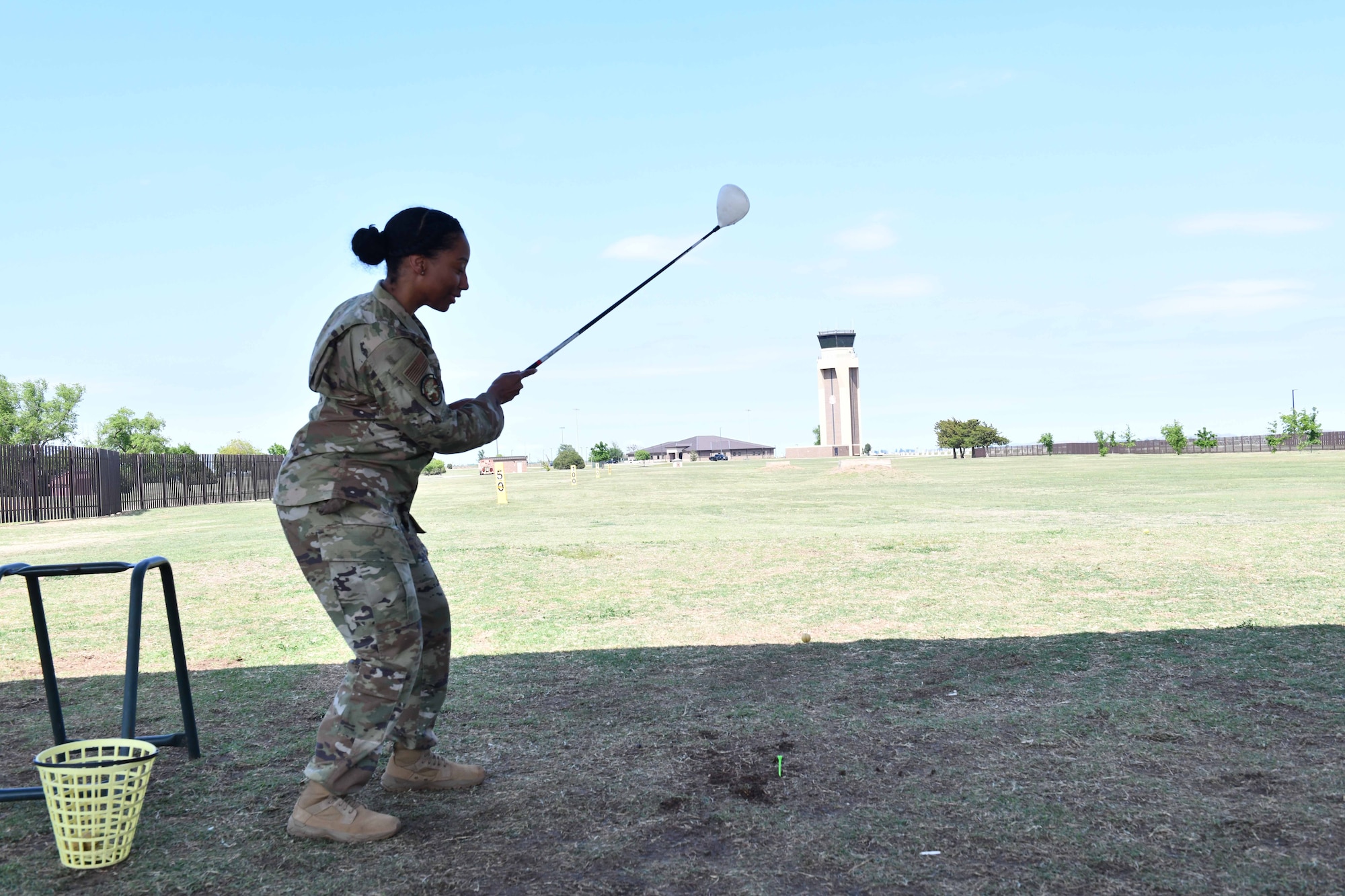 U.S. Air Force Dondra Simmons, 97th Force Support Squadron senior enlisted leader, hits a golf ball during a “Driving Out Sexual Assault” event at Altus Air Force Base, Oklahoma, May 3,2023. Sexual Assault Prevention month concluded with the “Drive Out Sexual Assault” event.(U.S. Air Force photo by Airman 1st Class Miyah Gray)