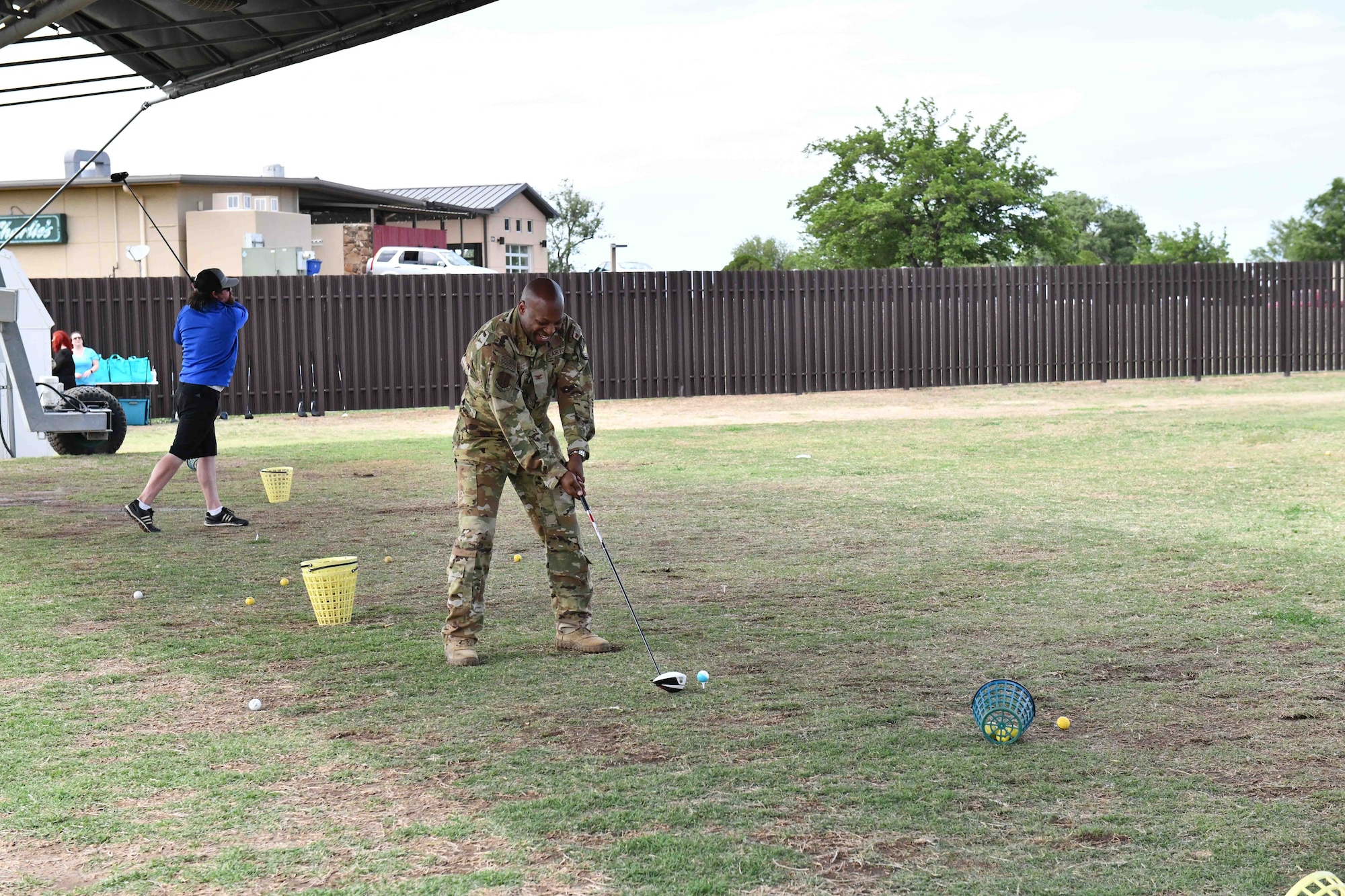 U.S. Air Force Col. Patrick Brady-Lee, 97th Air Mobility Wing vice commander, prepares to hit a golf ball during a “Driving Out Sexual Assault” event at Altus Air Force Base, Oklahoma, May 3,2023. More than 15 people signed the pledge to prevent sexual assault. (U.S. Air Force photo by Airman 1st Class Miyah Gray)