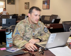 Lt Col Daniel Montes reviews his notes prior to working on the final report during the Space Mishap Investigation Course