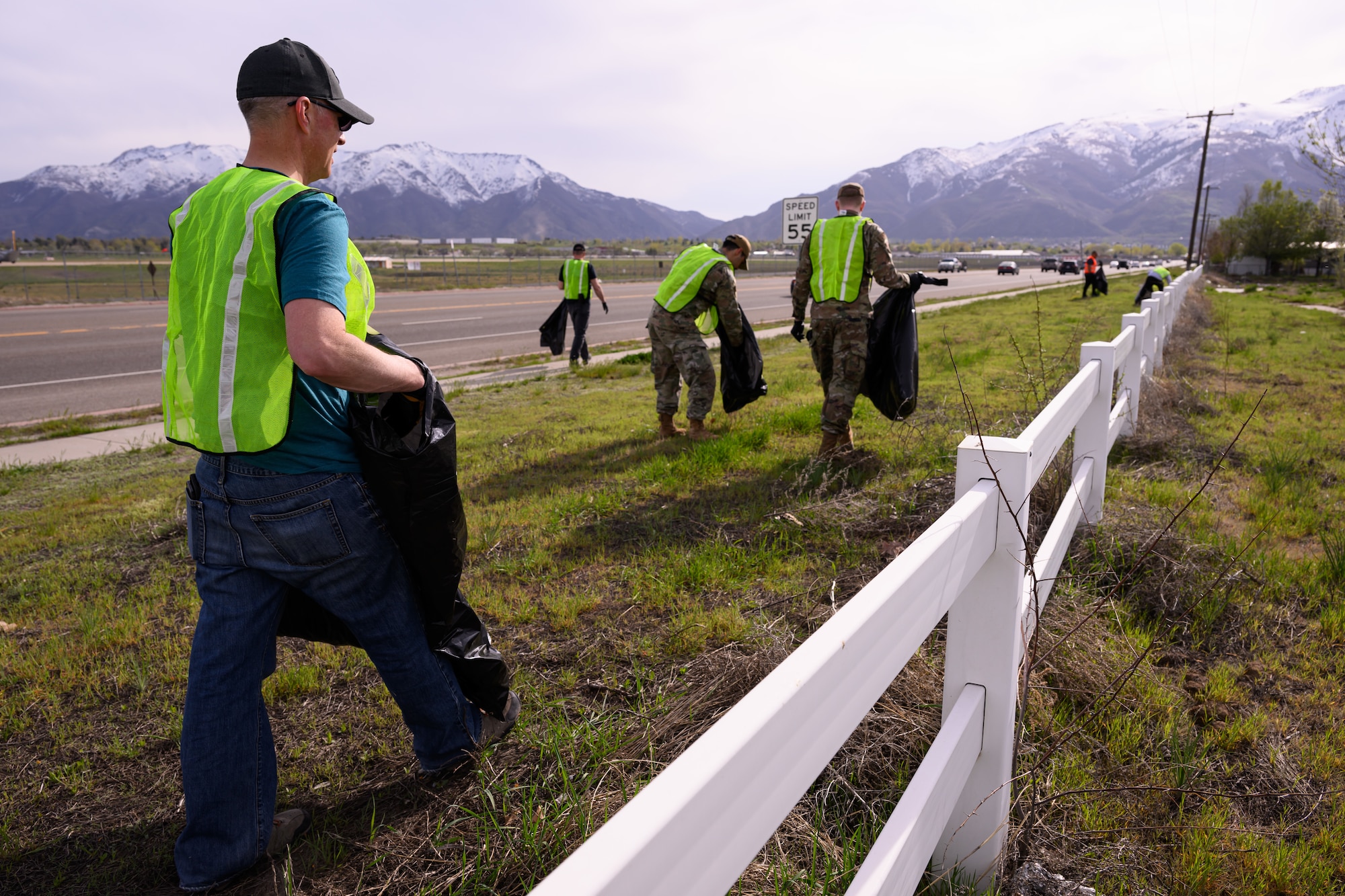 Airmen collect trash along the highway.