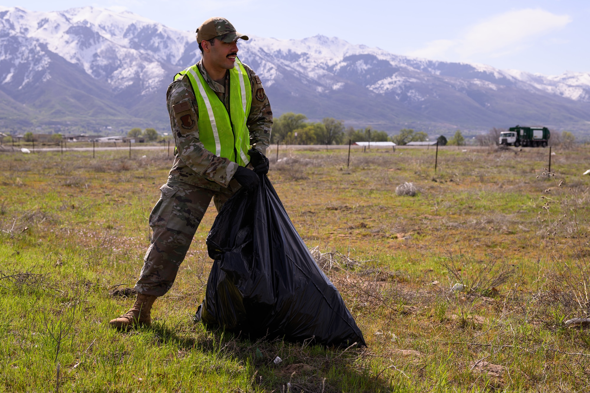 Airmen collect trash along the highway.