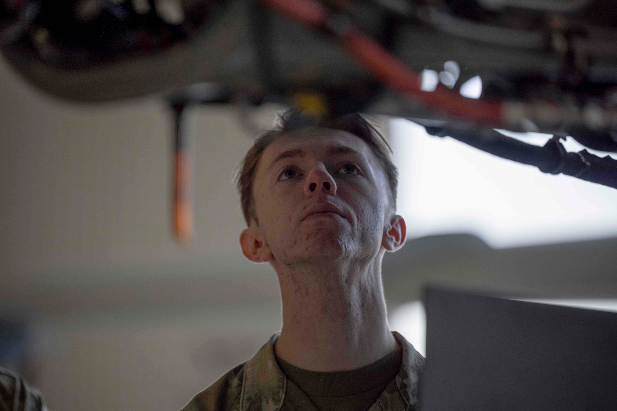 U.S. Air Force Airman 1st Class Alexander MacWithey, 49th Component Maintenance Squadron precision measurement equipment laboratory journeyman, examines the engine of an MQ-9 Reaper during a job swap event at Holloman Air Force Base, New Mexico, April 28, 2023. The purpose of the event was for Airmen to go out to different groups and squadrons to shadow other career fields. (U.S. Air Force photo by Senior Airman Antonio Salfran)