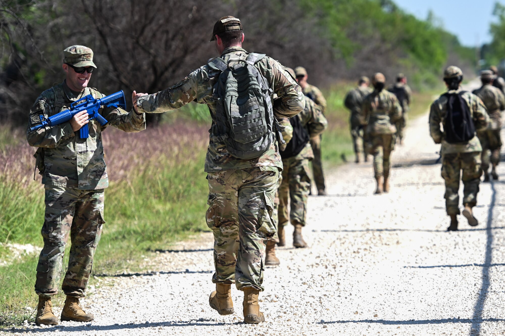 U.S. Air Force Col. Matthew Altman (left), 47th Mission Support Group commander, fist bumps Staff Sgt. Nicholas Johnson, 47th Contracting Squadron contract specialist, during a training exercise at Laughlin Air Force Base, Texas, on April 28, 2023.