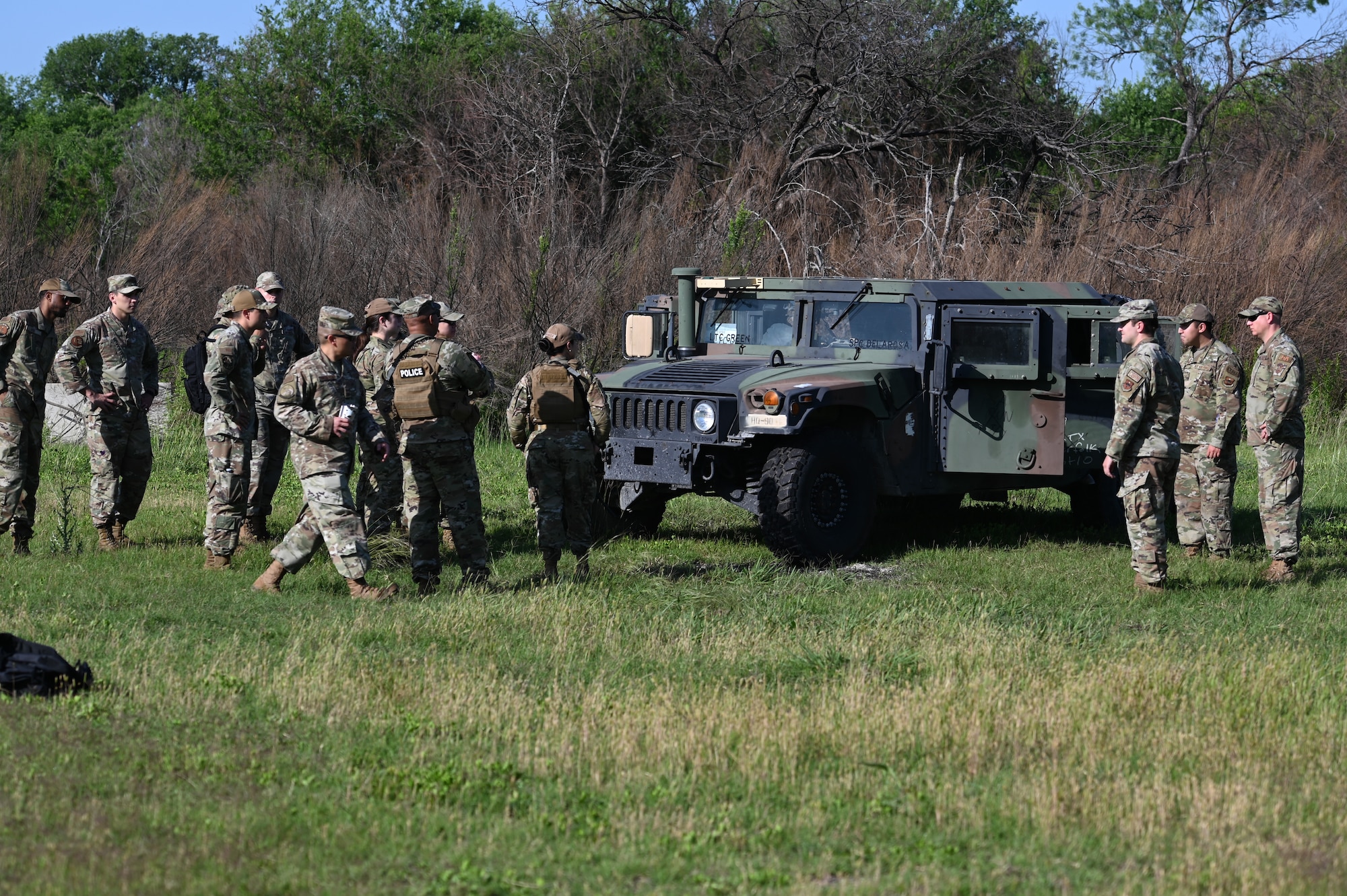 U.S. Air Force Airmen from the 47th Mission Support Group gather around a Humvee for training at Laughlin Air Force Base, Texas, on April 28, 2023.