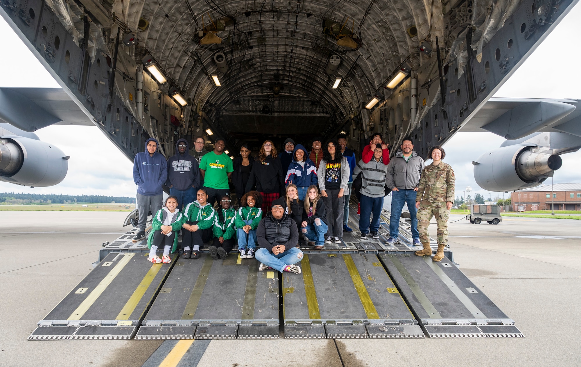 Students from Clover Park High School pose for a photo on the ramp of a C-17 Globemaster III during a tour at Joint Base Lewis-McChord, Washington, May 4, 2023. In addition to touring a C-17 Globemaster III, students were able to tour the 22nd Special Tactics Squadron and Heritage Hill Air Park, and receive a mission brief from U.S. Air Force Col. David Fazenbaker, commander of the 62d Airlift Wing. (U.S. Air Force photo by Staff Sgt. Rachel Williams)