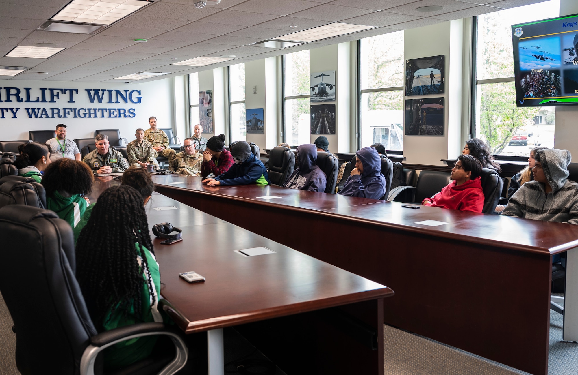 U.S. Air Force Col. David Fazenbaker, commander of the 62d Airlift Wing, gives a mission brief to Clover Park High School students during a tour at Joint Base Lewis-McChord, Washington, May 4, 2023. Along with the mission brief, students were able to tour the 22nd Special Tactics Squadron, Heritage Hill Air Park, and a C-17 Globemaster III. (U.S. Air Force photo by Staff Sgt. Rachel Williams)