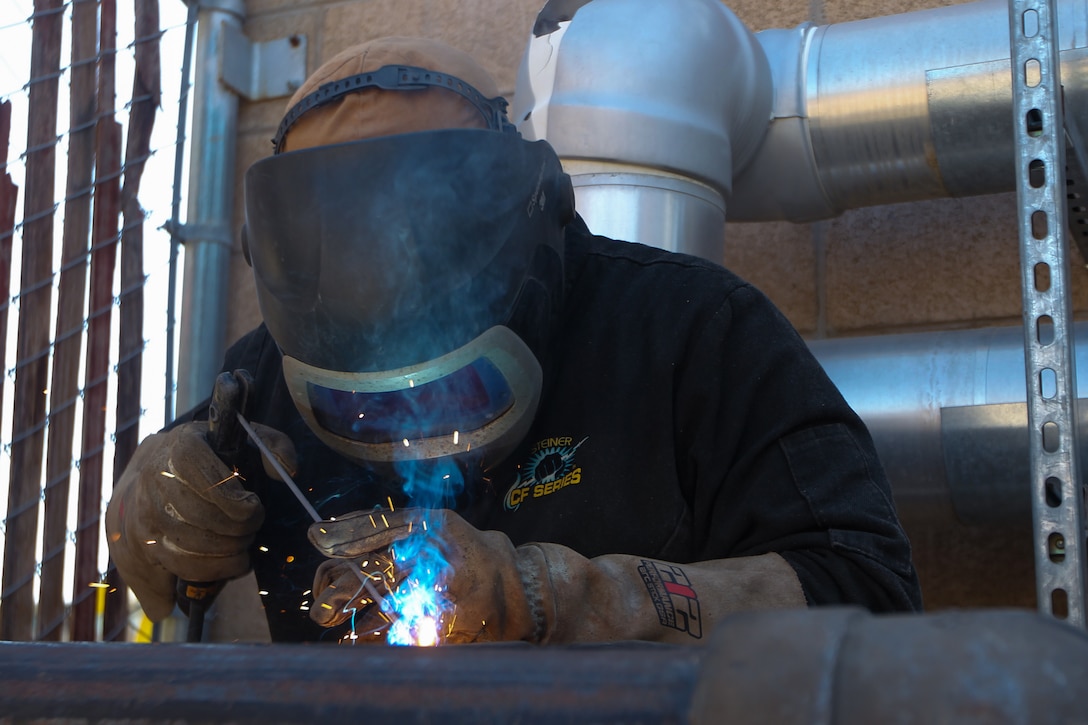 Daniel Evans, a welder with Public Works Division (PWD) welds a new pipe at Marine Corps Air Ground Combat Center, Twentynine Palms, California, April 26, 2023. PWD is responsible for maintaining and repairing the water supply network ensuring that water is provided to the Combat Center. (U.S. Marine Corps photo by Cpl. Jonathan M. Forrest)