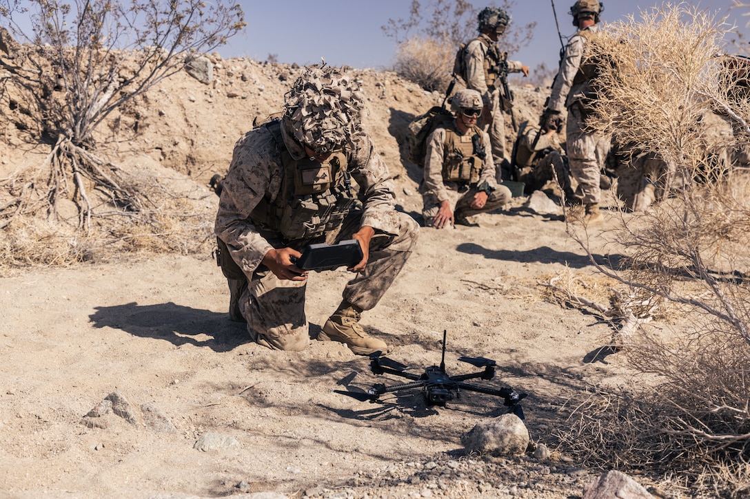 A US Marine prepares to launch an Skydio X2D quadcopter unmanned aircraft system